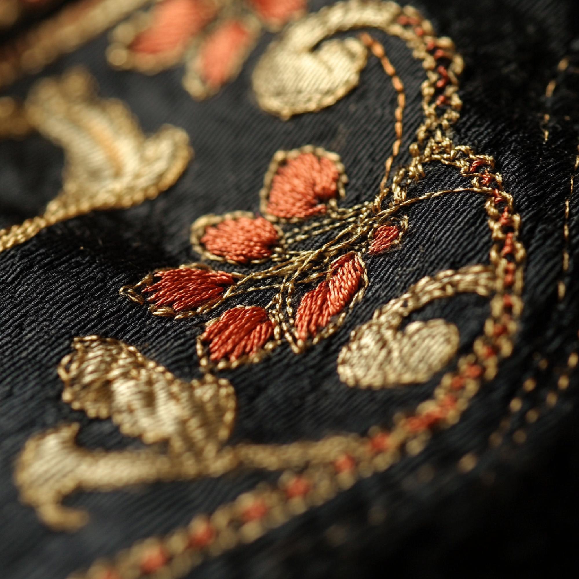 Close-up luxury gold thread embroidery on silk